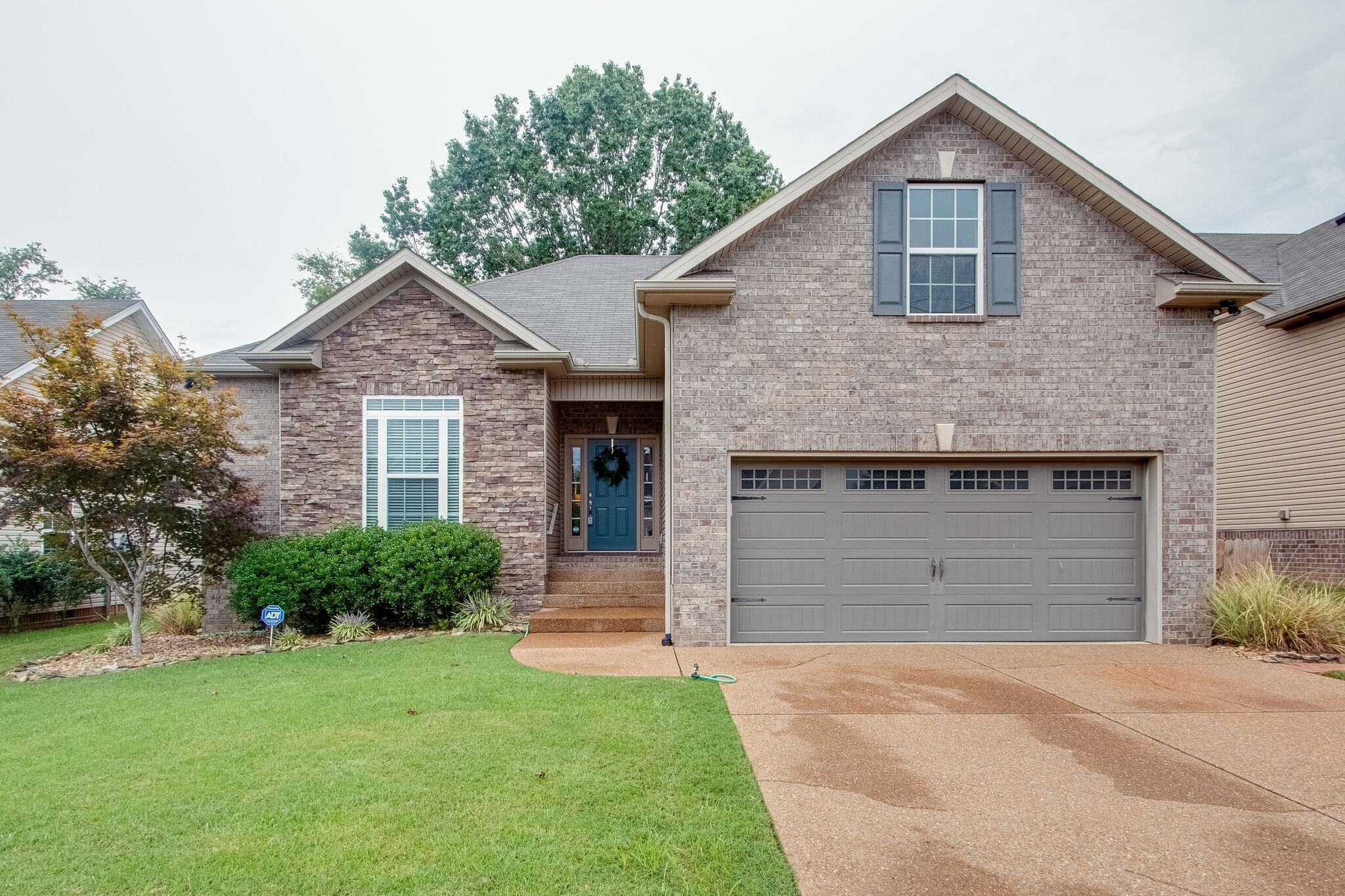1094 Golf View Way Spring Hill, TN 37174 - Photo 1 of 26 a front view of a house with a yard and garage