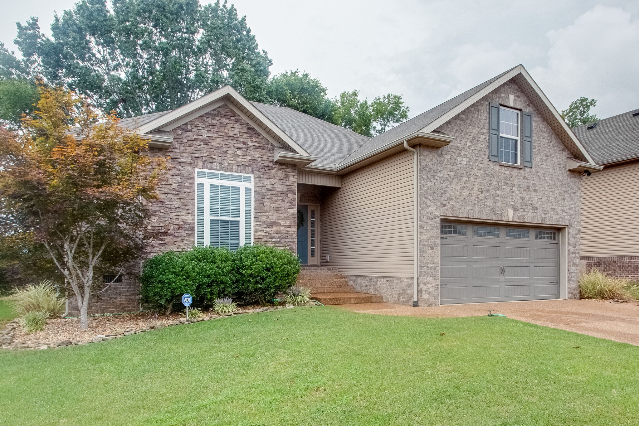 1094 Golf View Way Spring Hill, TN 37174 - Photo 2 of 26 a front view of a house with a yard and garage