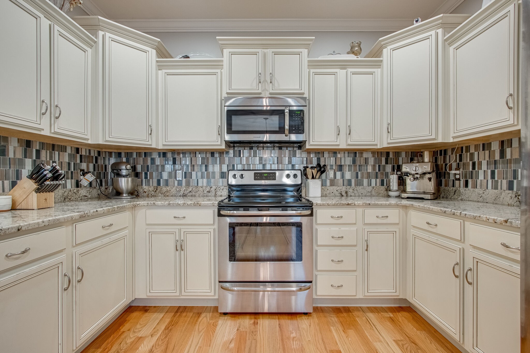 1094 Golf View Way Spring Hill, TN 37174 - Photo 12 of 26 a kitchen with stainless steel appliances granite countertop a stove and white cabinets