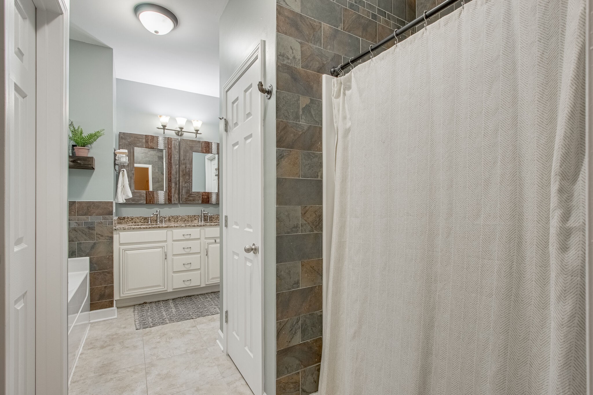 1094 Golf View Way Spring Hill, TN 37174 - Photo 17 of 26 a bathroom with a granite countertop sink and a mirror