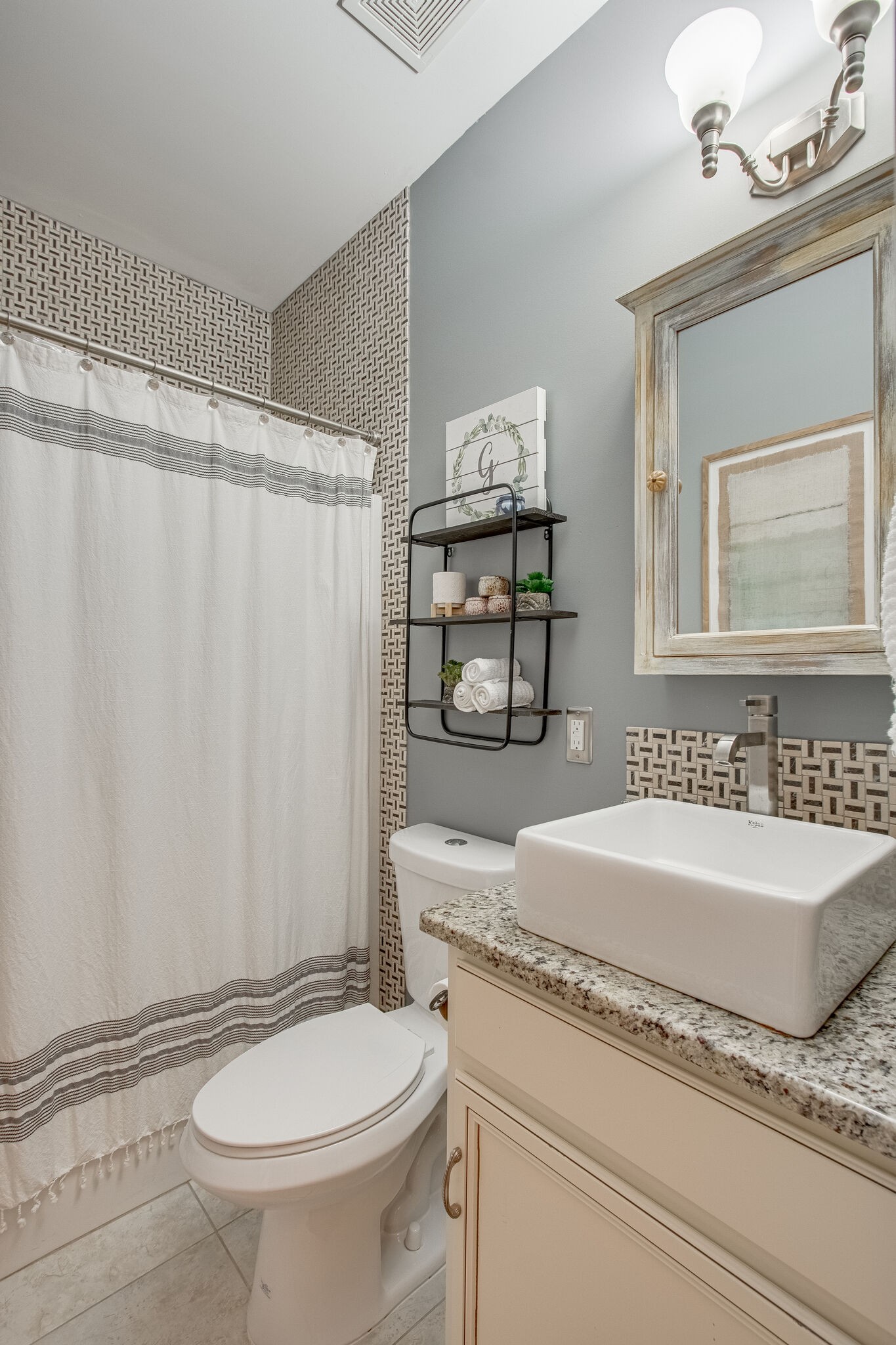 1094 Golf View Way Spring Hill, TN 37174 - Photo 24 of 26 a bathroom with a granite countertop sink and a mirror