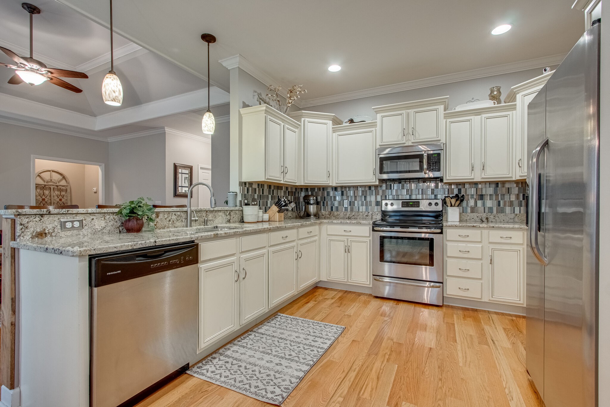 1094 Golf View Way Spring Hill, TN 37174 - Photo 10 of 26 a kitchen with kitchen island granite countertop a sink cabinets and stainless steel appliances