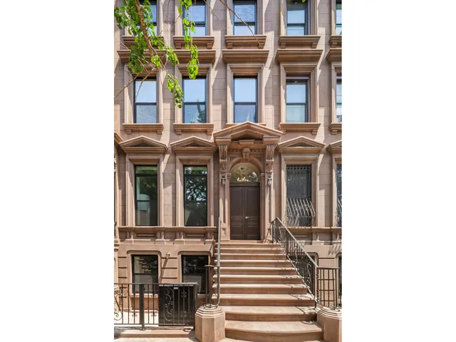 a view of a building with a door and a porch