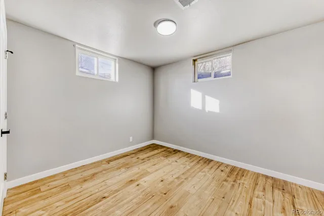 a view of a room with wooden floor and white walls