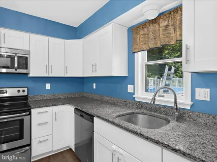 a view of a kitchen with microwave and cabinets