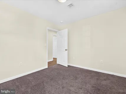a view of an empty room with a kitchen