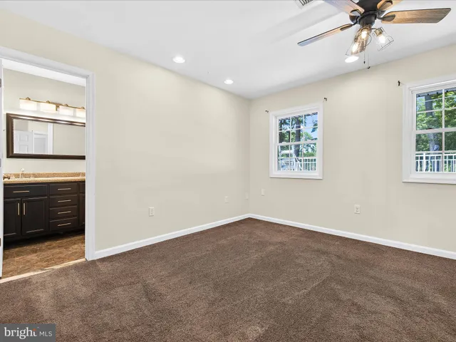 an empty room with a empty space and a ceiling fan