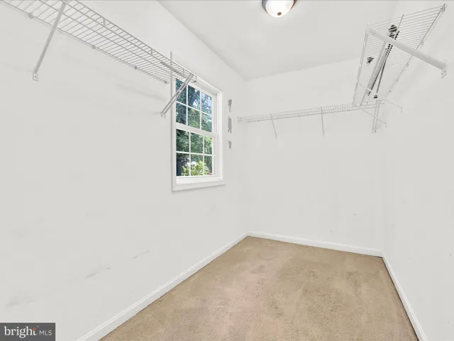 a bathroom with a granite countertop toilet sink and mirror