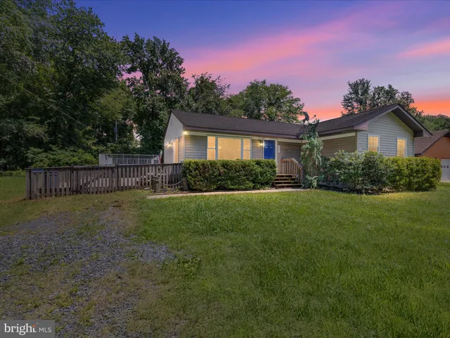 a view of a house with a yard and a garden