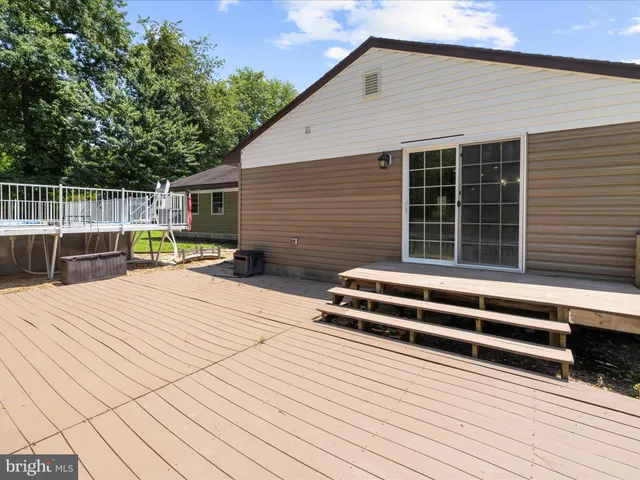 a view of a house with wooden floor and a bench
