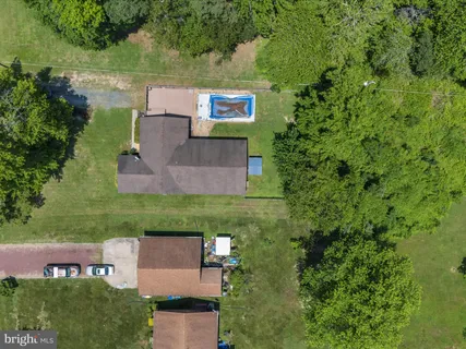 an aerial view of a house with outdoor space and street view