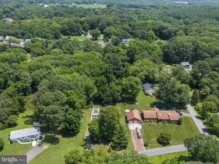 an aerial view of a city with lots of residential buildings and mountain view in back