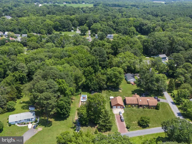 an aerial view of a city with lots of residential buildings and mountain view in back