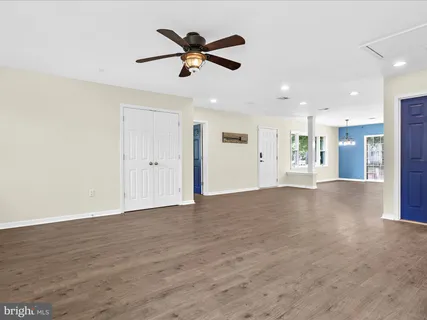 a view of an empty room with a ceiling fan