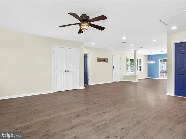 a view of an empty room with a ceiling fan