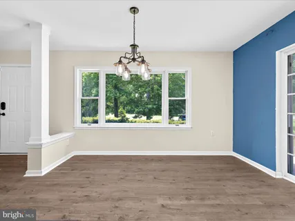 a view of a kitchen with a stove wooden cabinet and a refrigerator