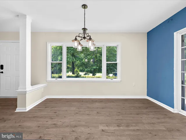 a view of a kitchen with a stove wooden cabinet and a refrigerator