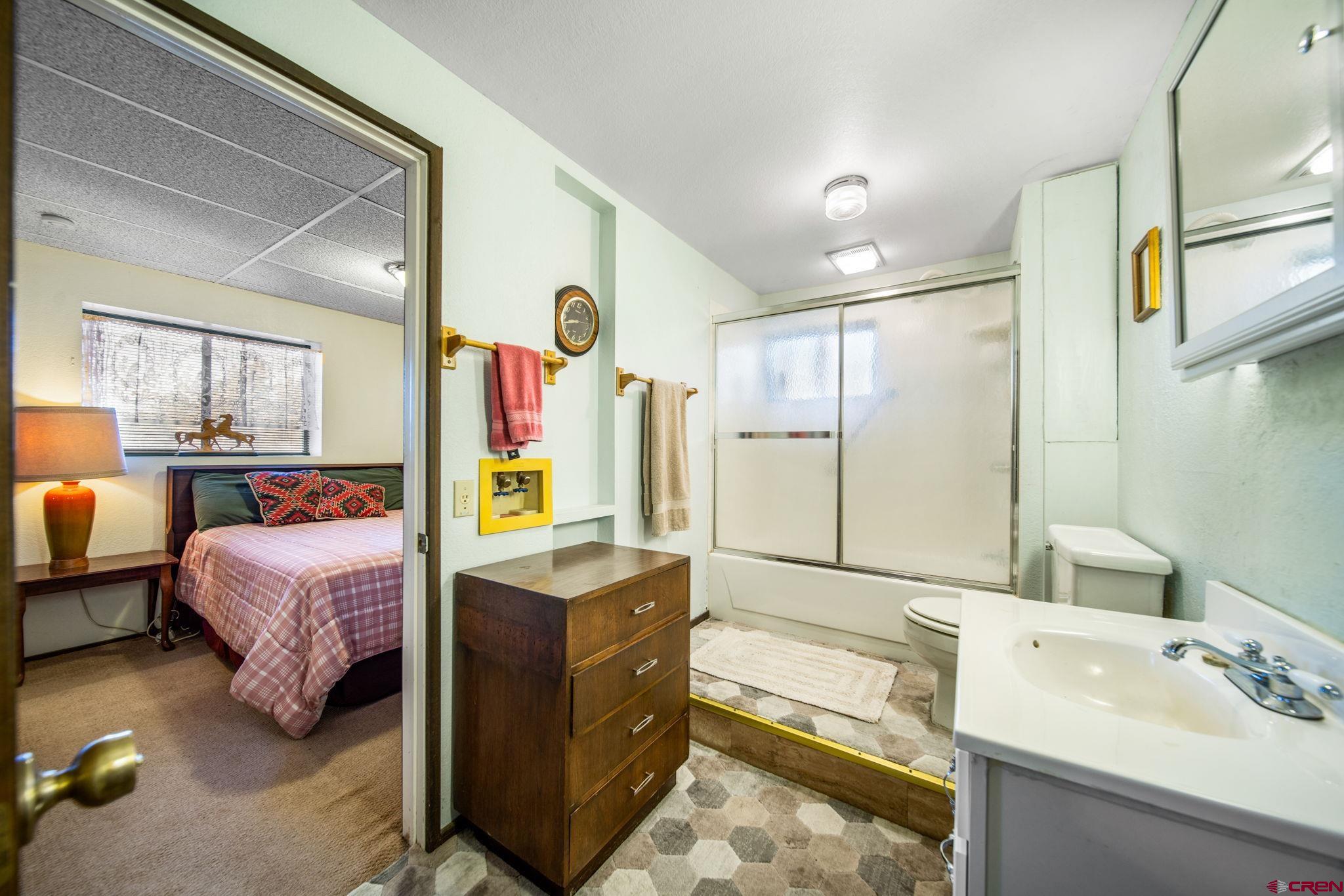 900 Spring Road Durango, CO 81303 - Photo 18 of 33 a spacious bedroom with a bed window and mirror