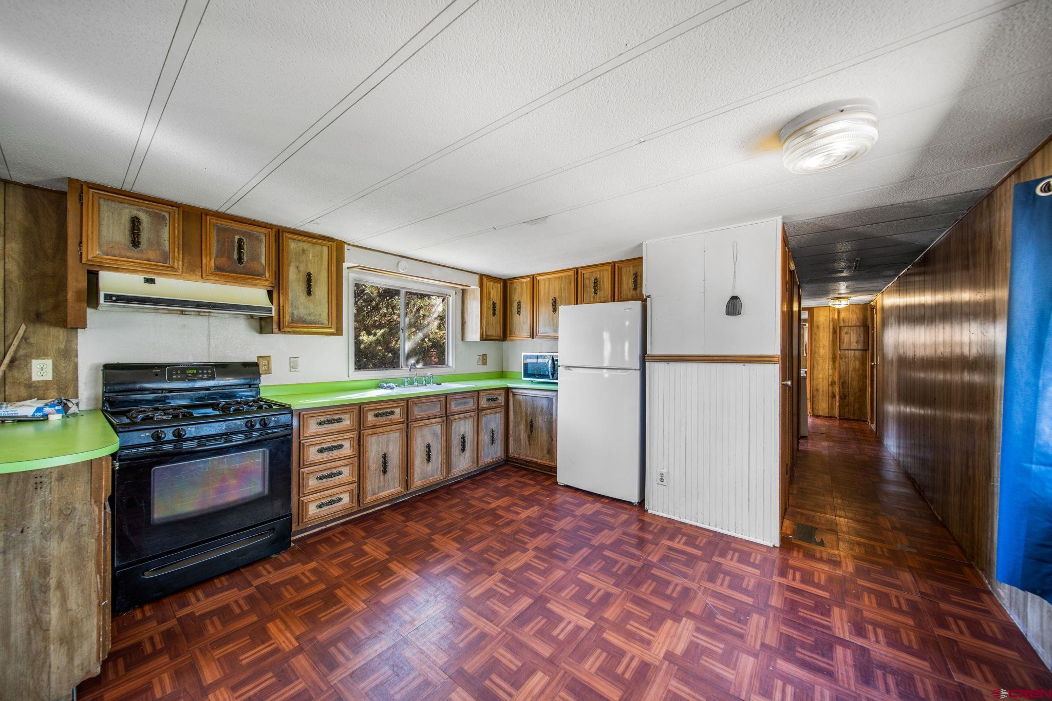 900 Spring Road Durango, CO 81303 - Photo 29 of 33 a kitchen with stainless steel appliances granite countertop a refrigerator a stove a sink and a oven