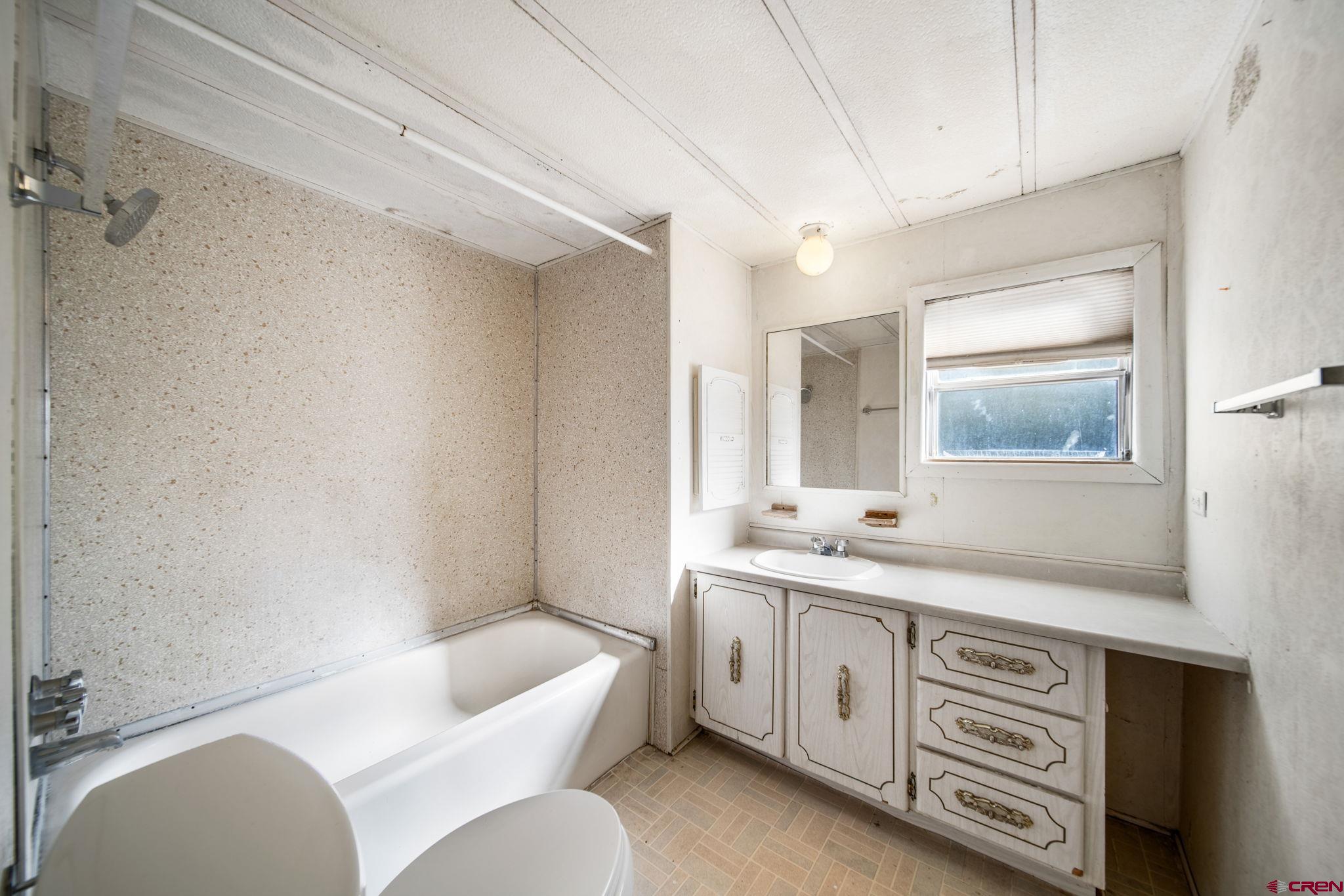 900 Spring Road Durango, CO 81303 - Photo 30 of 33 a spacious bathroom with a double vanity sink a toilet a mirror and