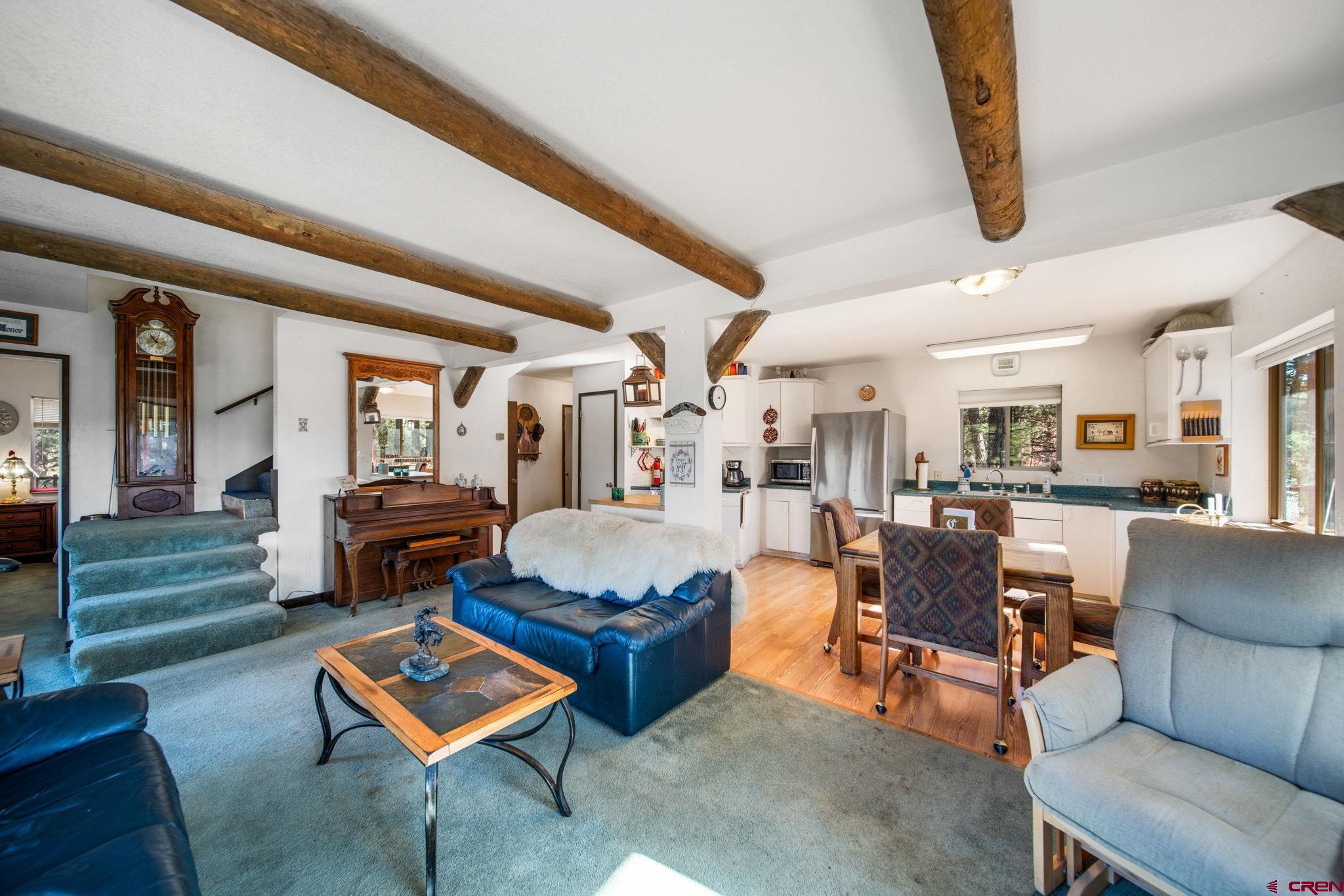 900 Spring Road Durango, CO 81303 - Photo 4 of 33 a living room with furniture and a dining table with wooden floor