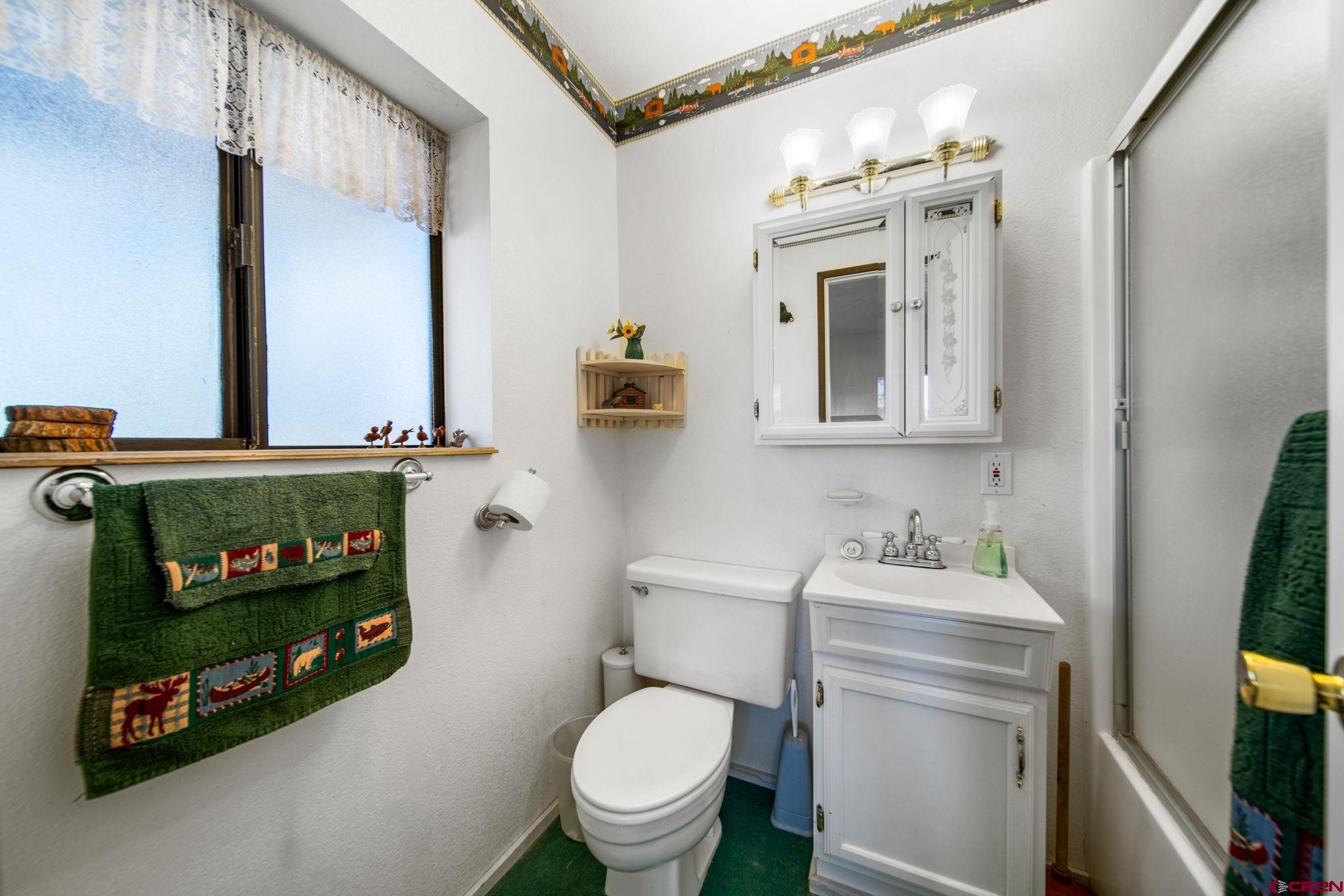900 Spring Road Durango, CO 81303 - Photo 6 of 33 a bathroom with a toilet sink and mirror