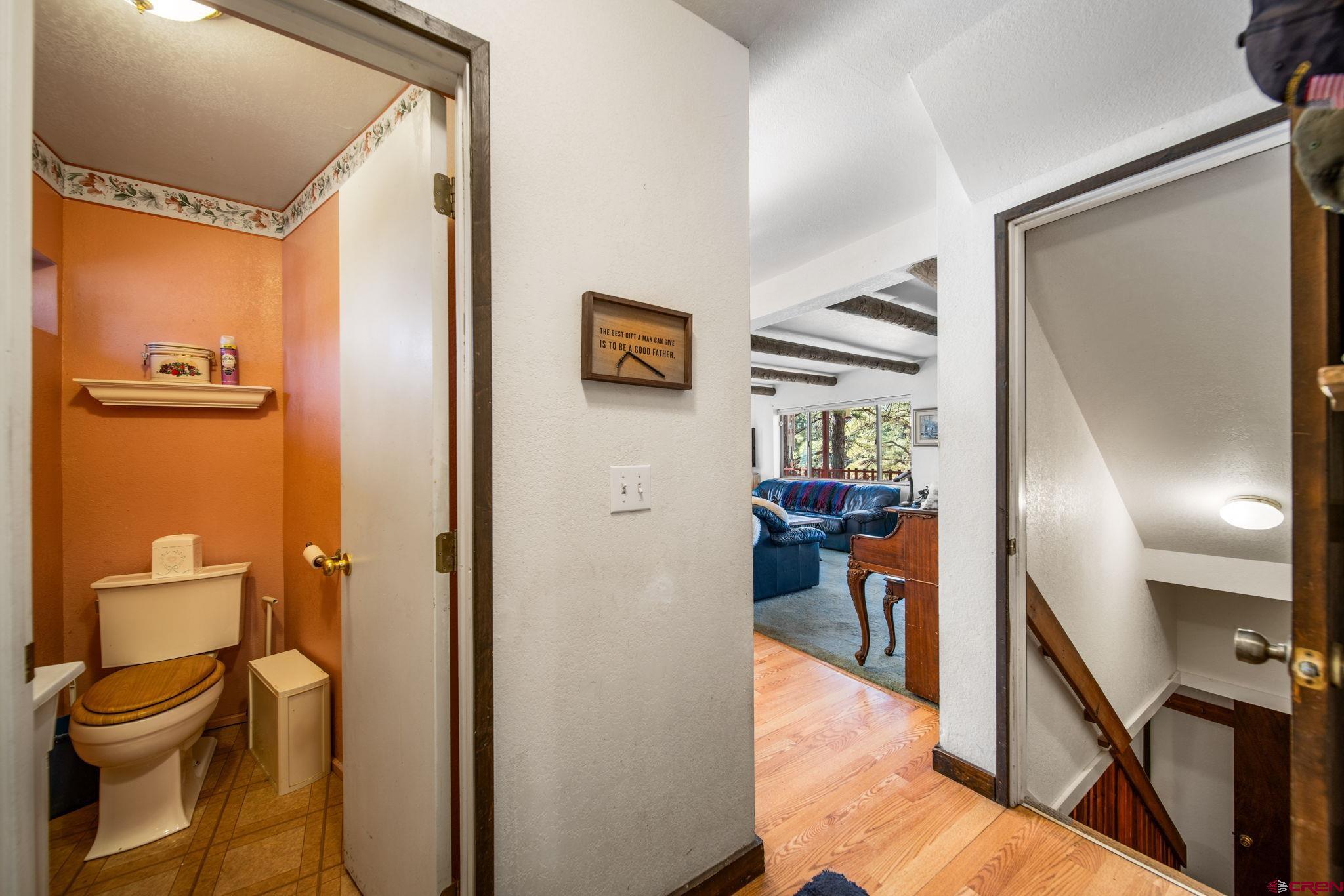 900 Spring Road Durango, CO 81303 - Photo 7 of 33 a view of a hallway with wooden floor and a bathroom