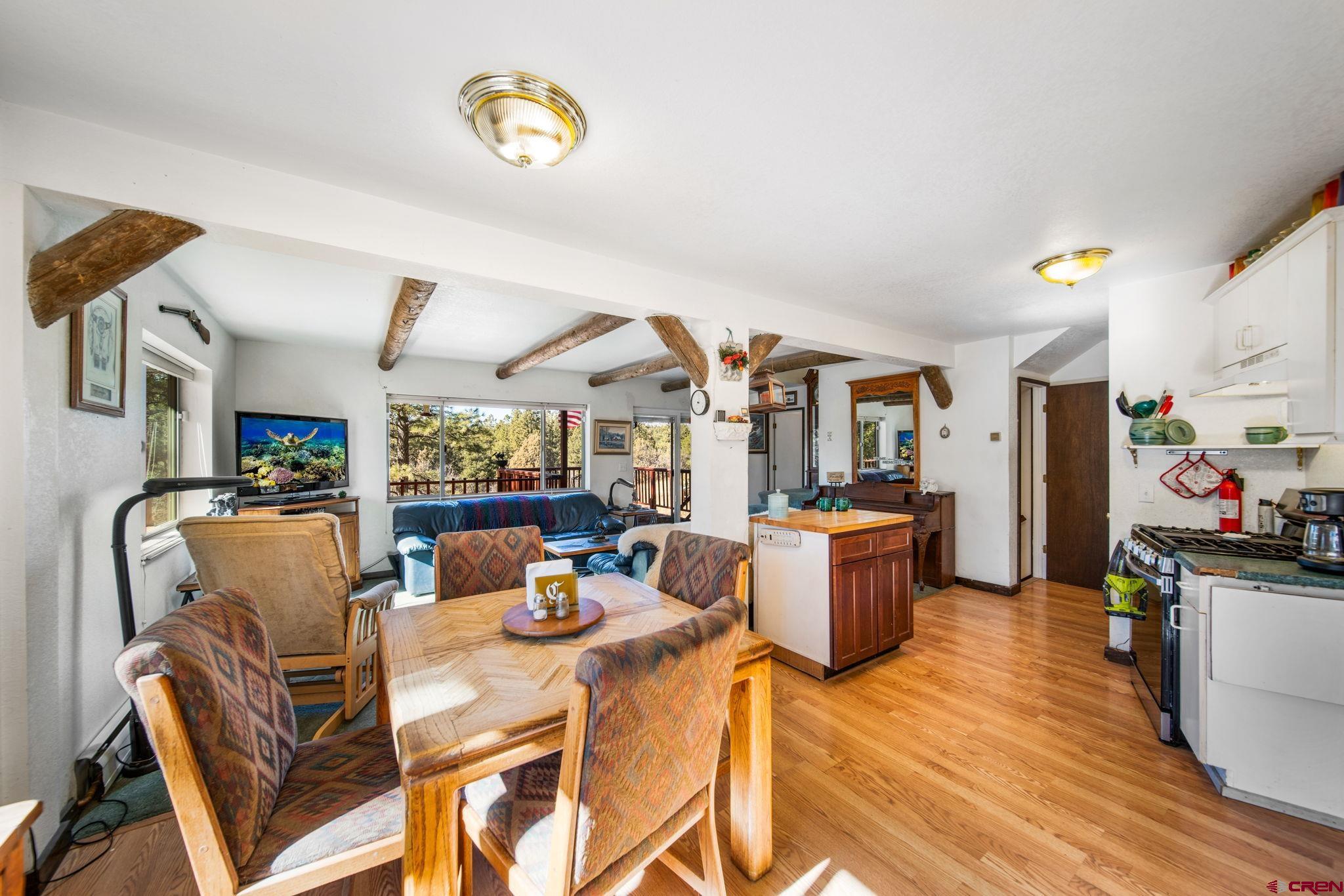 900 Spring Road Durango, CO 81303 - Photo 9 of 33 a dining room with furniture and wooden floor