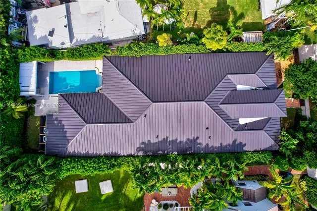 a kitchen with stainless steel appliances kitchen island granite countertop a stove a sink a refrigerator and chairs