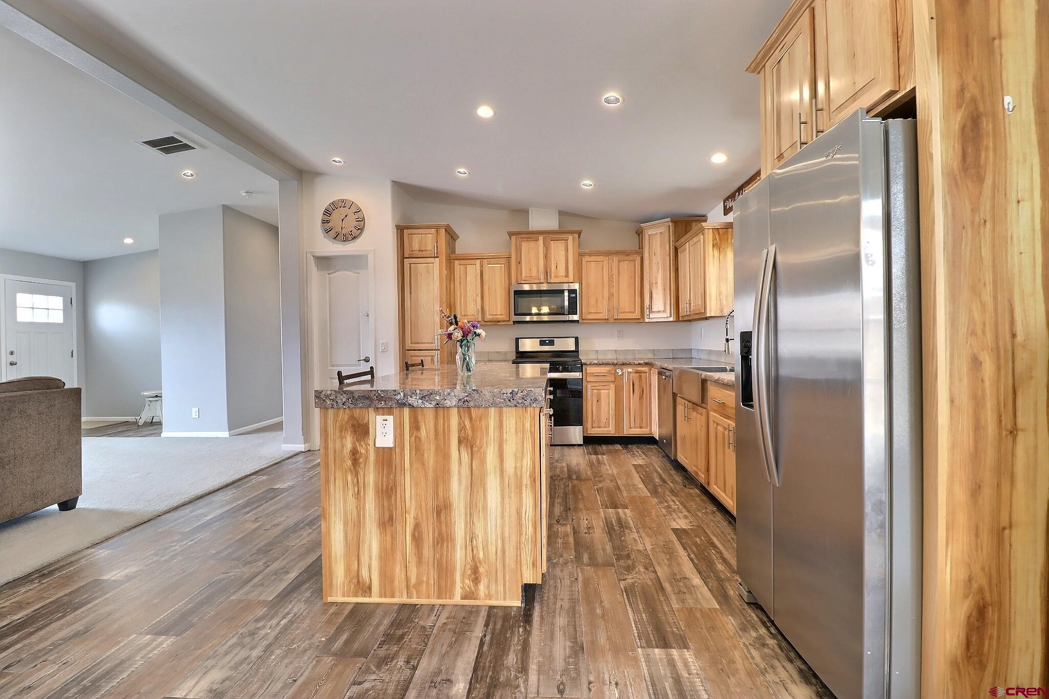 808 1525th Road Delta, CO 81416 - Photo 13 of 43 a kitchen with stainless steel appliances granite countertop a refrigerator and a stove top oven