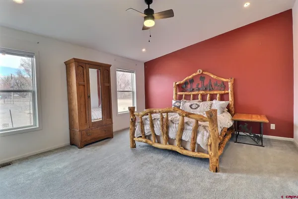 a bedroom with a bed table and window