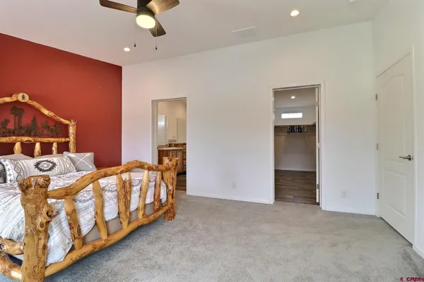 a bedroom with three beds and ceiling fan