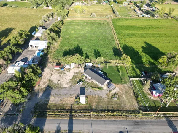 a building with swimming pool and lawn chairs