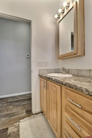 a bathroom with a granite countertop sink and a mirror