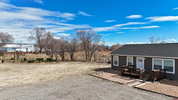 a view of house with yard outdoor seating area and barbeque oven