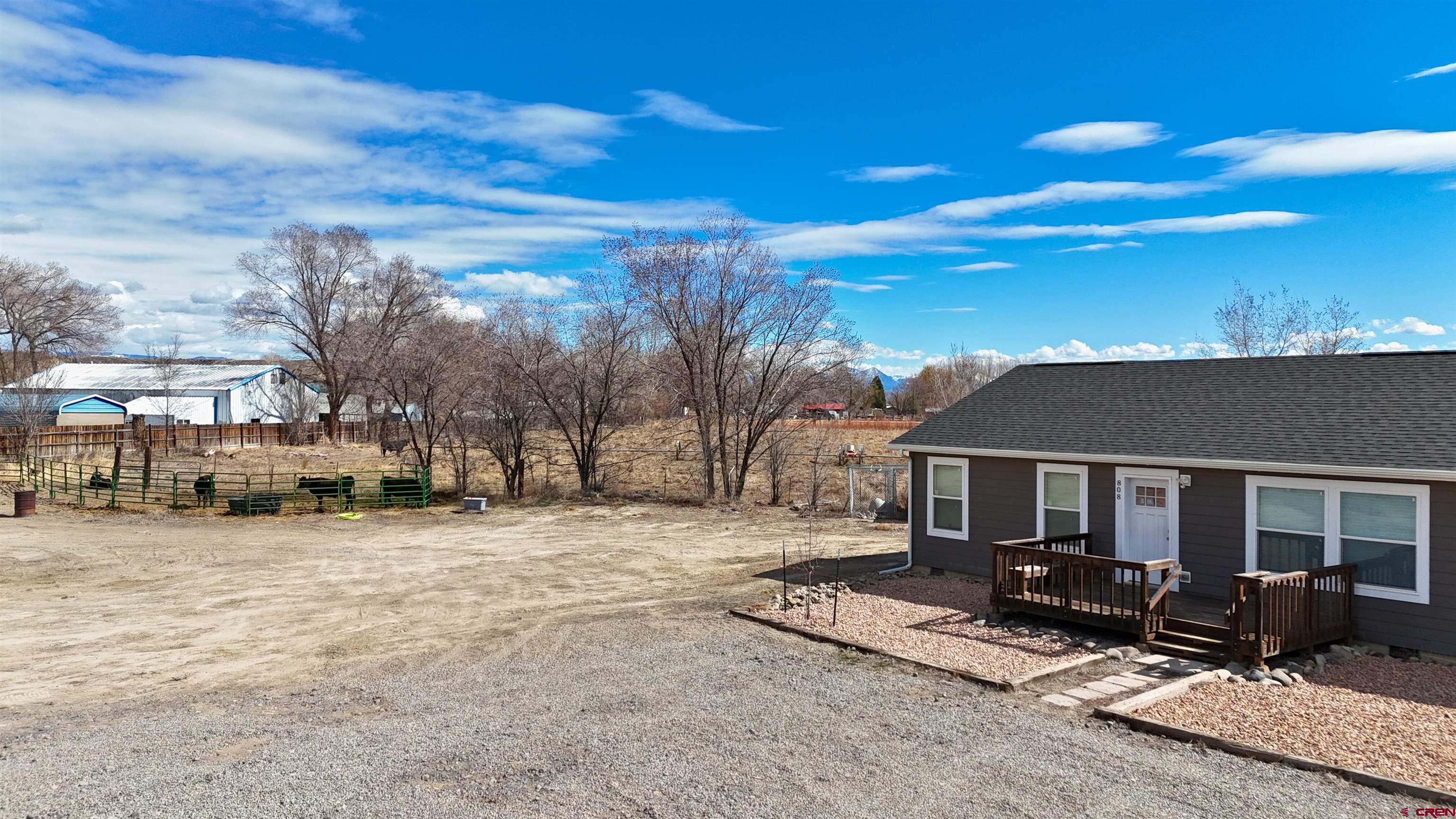 808 1525th Road Delta, CO 81416 - Photo 4 of 43 a view of house with yard outdoor seating area and barbeque oven