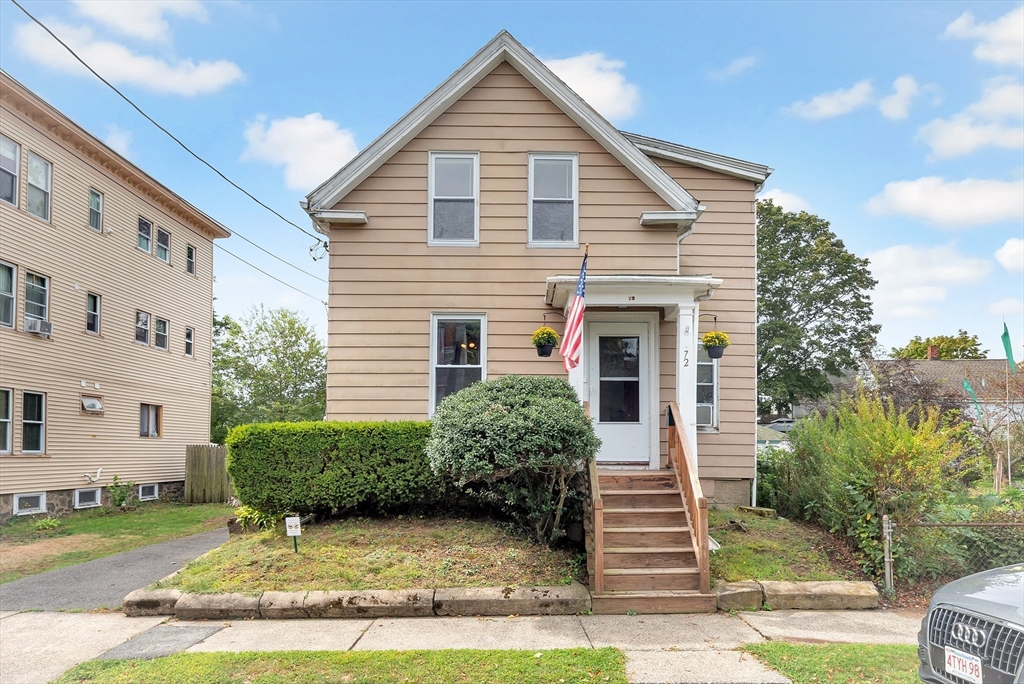 a view of a house with a yard and plants