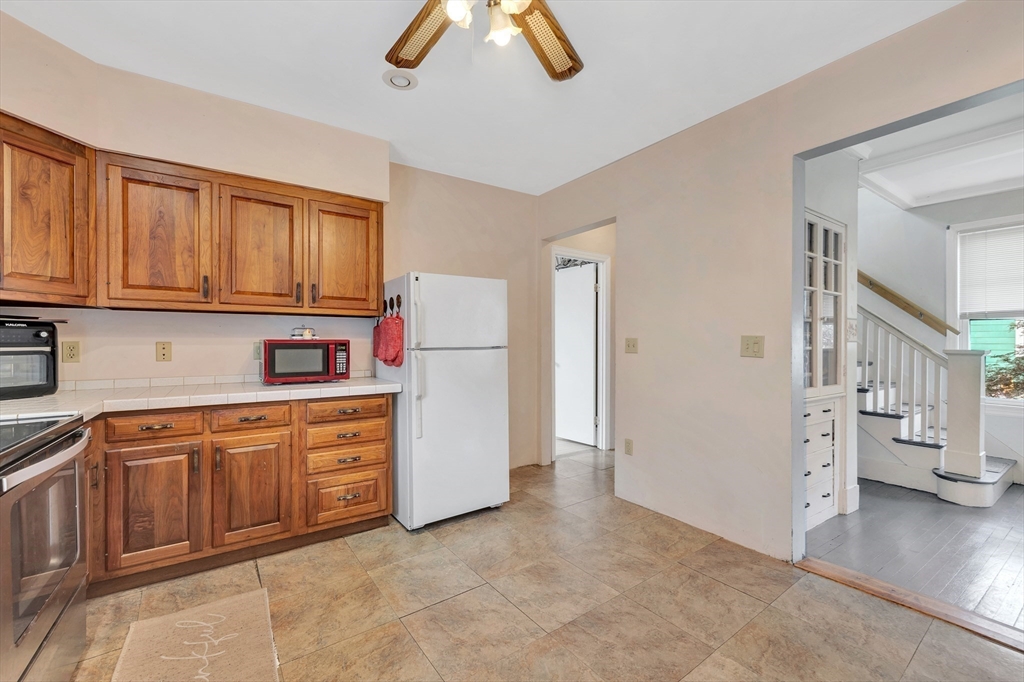 72 Hillside Avenue Lynn, MA 01902 - Photo 15 of 36 a kitchen with cabinets and a refrigerator