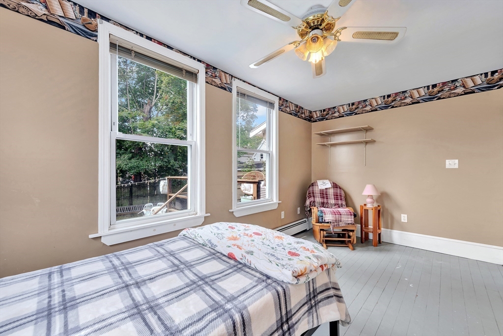 72 Hillside Avenue Lynn, MA 01902 - Photo 25 of 36 a bedroom with a bed and a chandelier