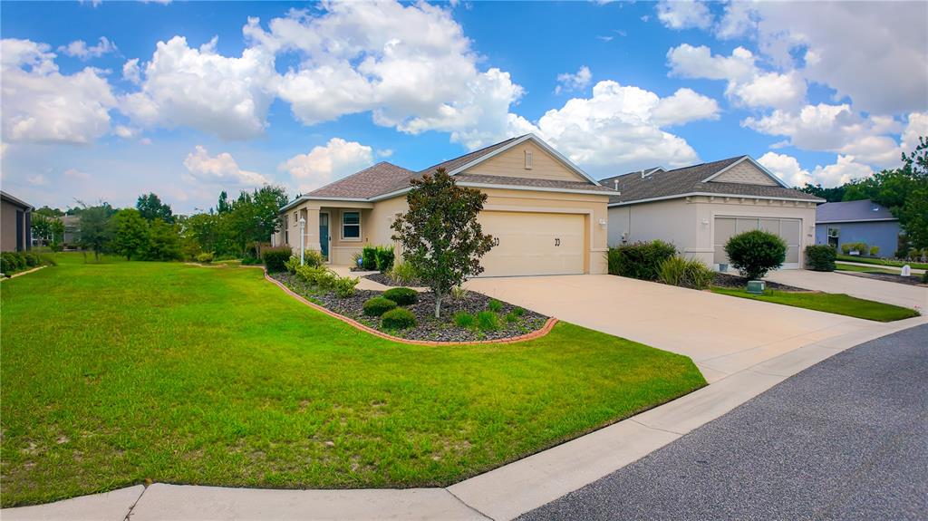 7765 Southwest 86th Loop Ocala, FL 34476 - Photo 1 of 1 a front view of a house with garden