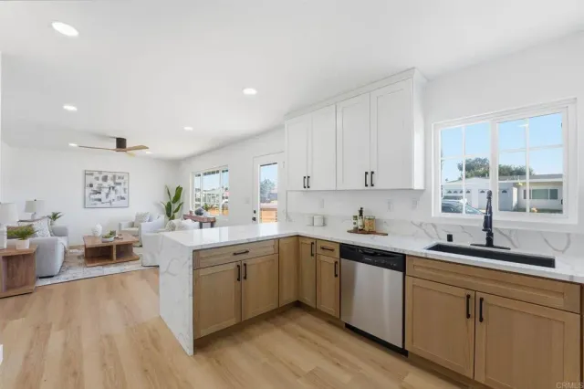 a kitchen with a sink cabinets and window