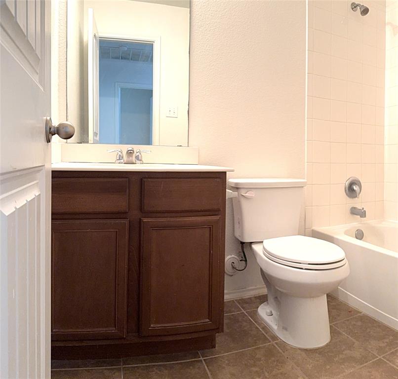 1104 Rainer Drive Princeton, TX 75407 - Photo 12 of 20 a bathroom with a toilet sink and mirror