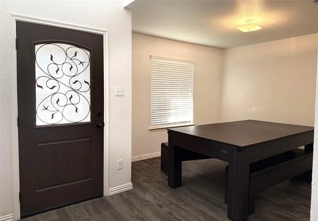 a room that has a table chair and a window