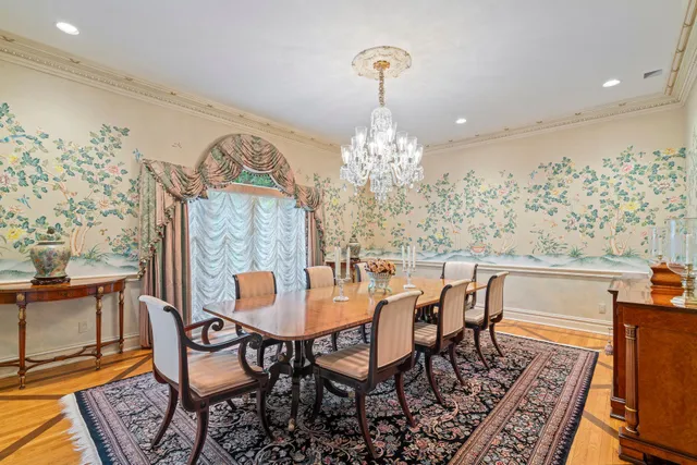 a view of a dining room with furniture and chandelier