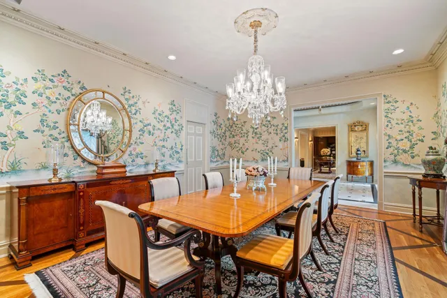 a view of a dining room with furniture and chandelier