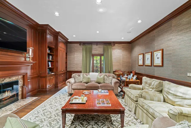a living room with furniture fireplace and flat screen tv