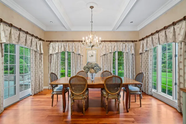 a view of a dining room with furniture wooden floor and chandelier