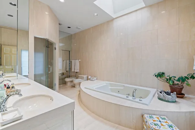 a bathroom with a tub sink and mirror