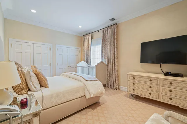 a spacious bedroom with a bed and a window