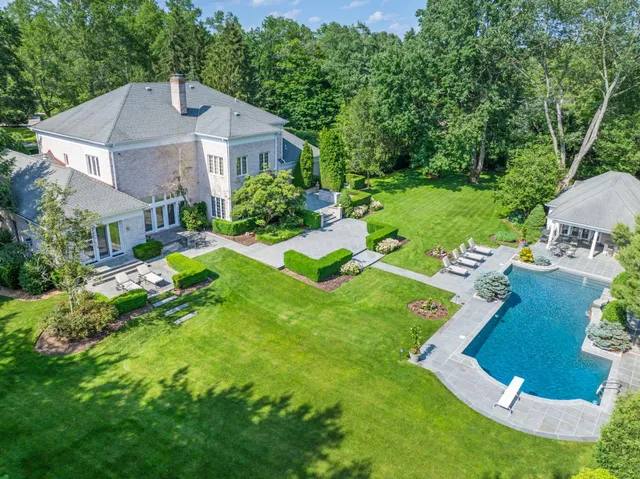 a view of a patio with couches and table and chairs and potted plants
